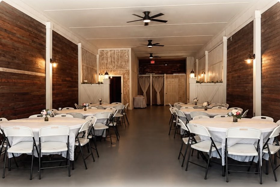 The main hall at Spring Street Social set with round tables, white linens and fresh flowers