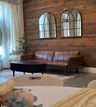 A leather sofa and arched mirrors in the lounge corner